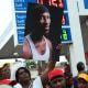 People gather at a gas station during a vigil to memorialize O'Shae Sibley