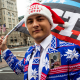 Wearing a red, white, and blue and winter-themed suit, Dylan Quattrucci waves a "Stop the Steal" flag during a rally