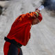 A member of the Prado fire crew tries to cool off in the  105 degree heat while putting out hotspots  at the Rabbit fire in Beaumont, Calif., on July 16, 2023.