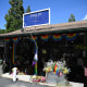 A Pride flag ripped off its flag pole is seen outside the entrance to the Mag.Pi clothing store is seen in Cedar Glen, near Lake Arrowhead, California, on August 21, 2023. The owner of the store, Laura Ann Carleton, was fatally shot on August 18 by a man who "made several disparaging remarks about a rainbow flag" displayed outside her store, according to the San Bernardino County Sheriff's department. The suspect was later killed during an encounter with deputies.