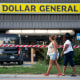 People walk past the Dollar General store where three people were shot and killed the day before  in Jacksonville, Fla. on Aug. 27, 2023.  Police say that the attack by a gunman on Black customers at the store that killed three is being investigated as a hate crime.