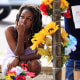 A woman pays her respects to shooting victims on Aug. 28, 2023 near the site of the Dollar General store shooting In Jacksonville, Fla.