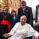 Pope Francis is greeted by Cardinal Giorgio Marengo, left, and faithful in Ulaanbaatar, Mongolia