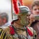  A performer in the Roman centurion costume talks to spectators