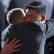 Lt. Dan Choi, a gay Army officer honorably discharged under "don't ask, don't tell," receives a hug before President Barack Obama signs the act lifting the ban on homosexuals serving openly in the U.S. armed forces at the Department of the Interior on Dec. 22, 2010.