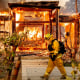 Woodbridge firefighter Joe Zurilgen passes a burning home as the Kincade Fire rages in Healdsburg, Calif., 