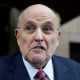 Rudy Giuliani speaks to reporters as he leaves his apartment building