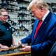 Former President Donald Trump examines a customized Glock pistol decorated with his name and likeness during a visit the Palmetto State Armory in Summerville, S.C., on Sept. 25, 2023.