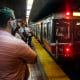 Commuters wait as a Red Line subway train arrives in Boston on July 13, 2022. 