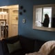 A potential home buyer is reflected in a mirror during an open house