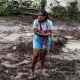 A woman stands in mud and debris in the Kilometro 42 community, near Acapulco, Mexico