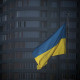 A Ukrainian flag flies in the square in front of the city hall