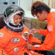 Mae Jemison smiles as a technician performs tests on her spacesuit.