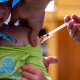 A three year old receives the Covid-19 vaccination