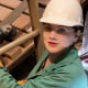 Kala stands on a ladder among her construction zone.