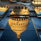 Sunrise hits the U.S. Capitol dome as it is reflected in marble panels