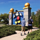 People walk past the entrance to Walt Disney World in Orland