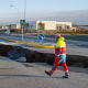 A member of the emergency services walks near a crack cutting across the main road in Grindavik, Iceland on Nov. 13, following earthquakes. 