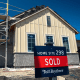 A "Sold" sign outside a house under construction