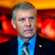 Rep. Barry Loudermilk listens to a speaker at a press conference.