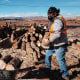 A member of the Navajo community with cut wood for delivery to local homes for cooking and heating on a reservation in Cameron, Ariz., on Dec. 15, 2021.  The wood was accessed through a partnership with the National Forest Foundation and their 'Wood for Life' initiative. 