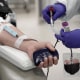 A registered nurse draws blood from a volunteer at a blood drive in San Diego
