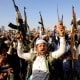 Image: Houthi fighters in Sanaa, the Yemeni capital, brandish weapons during a protest against American and British airstrikes on Jan. 12, 2024.