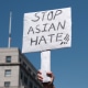 A protester holds a sign that reads  "Stop Asian Hate."