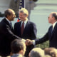 Israeli Prime Minister Menahem Begin, right, and Egyptian President Anwar Sadat, left, shaking hands after signing the Israeli-Egyptian peace treaty under the watch of President Jimmy Carter on the White House lawn on March 26, 1979.