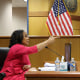 Fani Willis gestures while testifying as as Fulton County Superior Judge Scott McAfee watches.