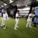 Tampa Bay Rays pitcher Zack Littell, left, dons a uniform for the team's MLB photo day during spring training Sunday, Feb. 18, 2024, in Port Charlotte, Fla. 