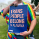 A person holds up a sign reading, "Trans People Belong in Alabama," during a rally outside the Alabama Statehouse in Montgomery, Ala., on International Transgender Day of Visibility, March 31, 2023. 