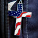 An American flag cross is worn