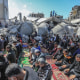 Palestinians perform Friday prayers around the ruins of Al-Farouq Mosque