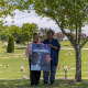 Jimmy Atchison's aunt Tammie Featherstone, and his father Jimmy Hill hold a sign that reads "Justice for Jimmy Atchison.