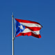 The Puerto Rican flag flies above the grounds of the Senate of Puerto Rico building in San Juan