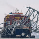 The collapsed Francis Scott Key Bridge lies on top of the container ship Dali in Baltimore
