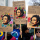 People carry posters with images of slain Brazilian councilwoman Marielle Franco