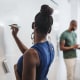 Woman holding pen looking at teacher and students standing in language class