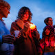 People light candles during a vigil