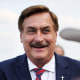 Mike Lindell smiles while greeting guests 