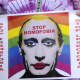 A demonstrator holds a poster depicting Russian President Vladimir Putin with make-up during a protest