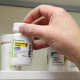 A pharmacist removes a bottle of Misoprosto from a shelf at a pharmacy in Provo, Utah