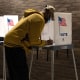 Voters cast ballots at a polling location in Southfield, Mich.