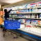 A customer shops for milk at a grocery store.