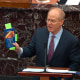 David Schoen, an attorney for former President Donald Trump, holds up a copy of the U.S. Constitution as he speaks during the second impeachment trial of Trump 