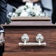 Coffin, people and funeral with death, grief and service with family carry casket to grave outdoor. Rip, farewell and ceremony or event for dead person together in respect, religion and spiritual
