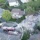 aerial firefighter trucks house explosion aftermath new jersey smoke debris destruction