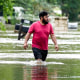 A man walks through floodwaters