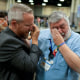 Rev. Andy Oliver, left, and David Meredith wipe away tears after an approval vote at the United Methodist Church General Conference.